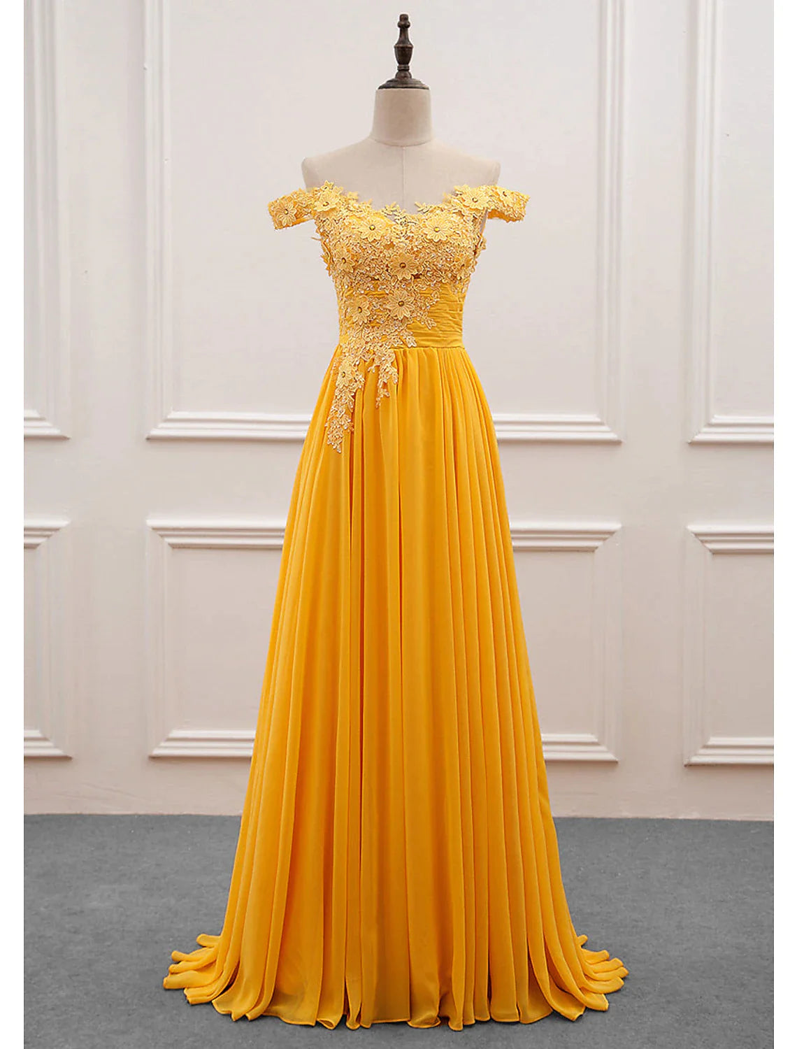 Elegant A-line off-shoulder chiffon gown with appliques.