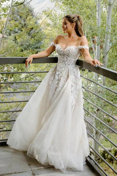 Elegant A-line off-shoulder bridal gown with delicate appliques.