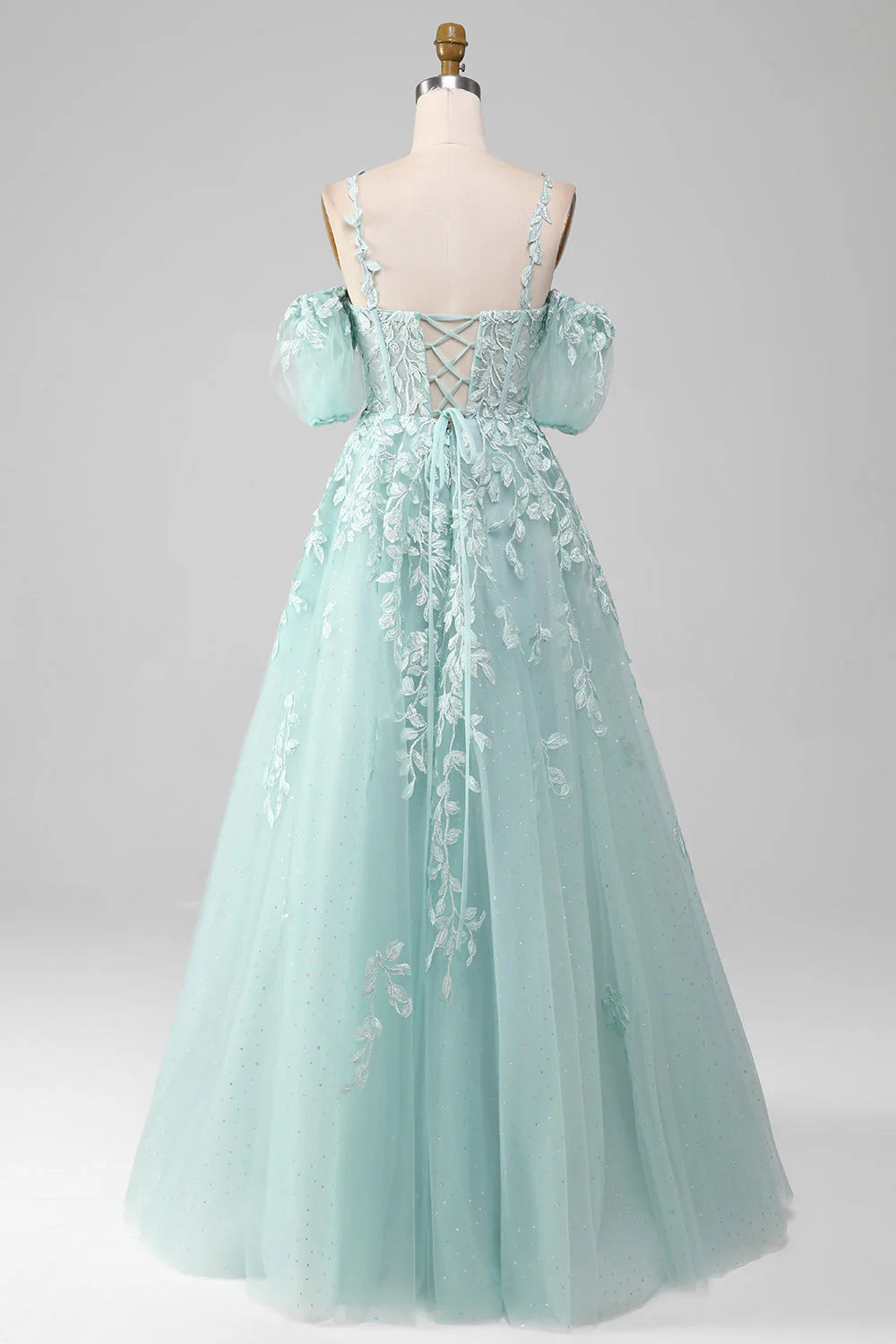 Back view of the mint green off-shoulder gown, showcasing the flowing A-line skirt.