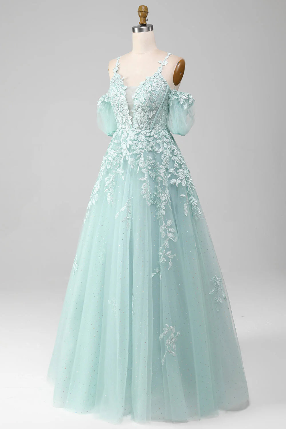 Close-up of the beaded bodice and appliques on the mint green off-shoulder dress.