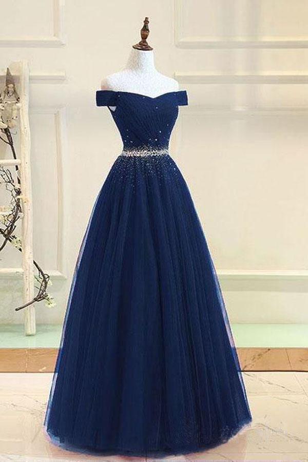 Close-up of the beaded bodice and off-shoulder neckline on a tulle prom dress.