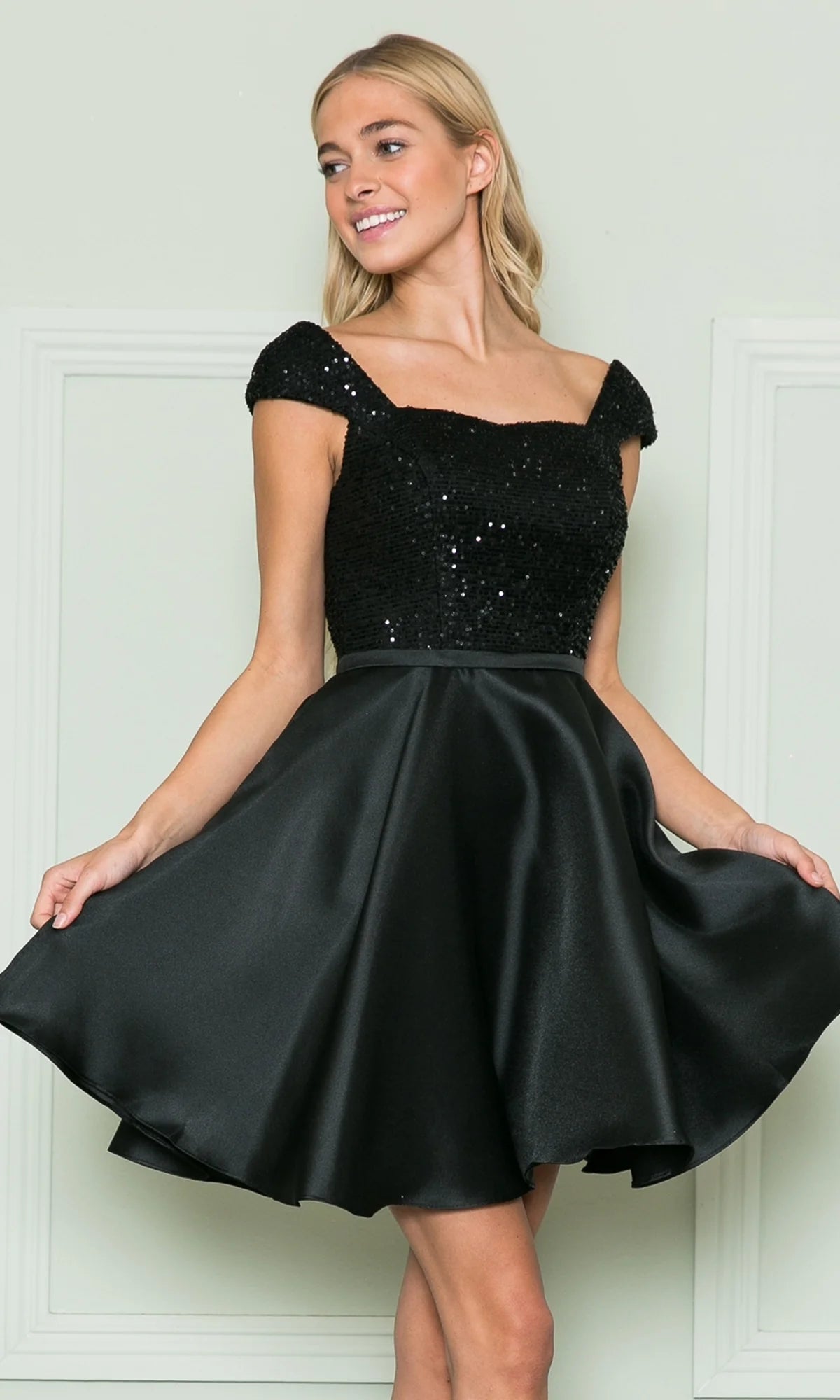 Elegant black A-line homecoming dress with off-shoulder cap sleeves and sequin bodice.