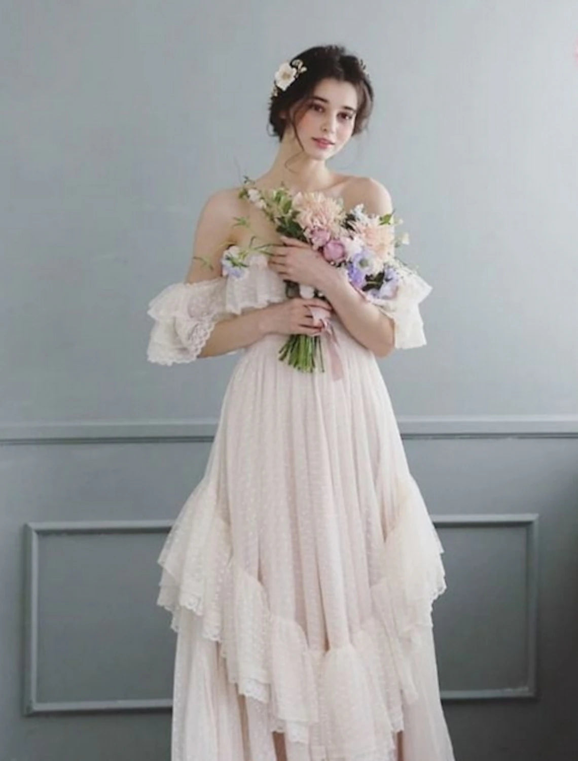 Close-up of the off-shoulder neckline and cap sleeves on the wedding dress.