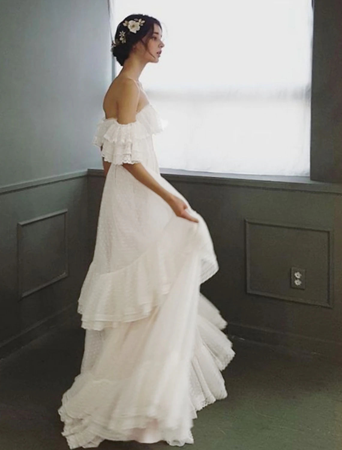 Full length view of the elegant off-shoulder cap sleeve wedding dress.