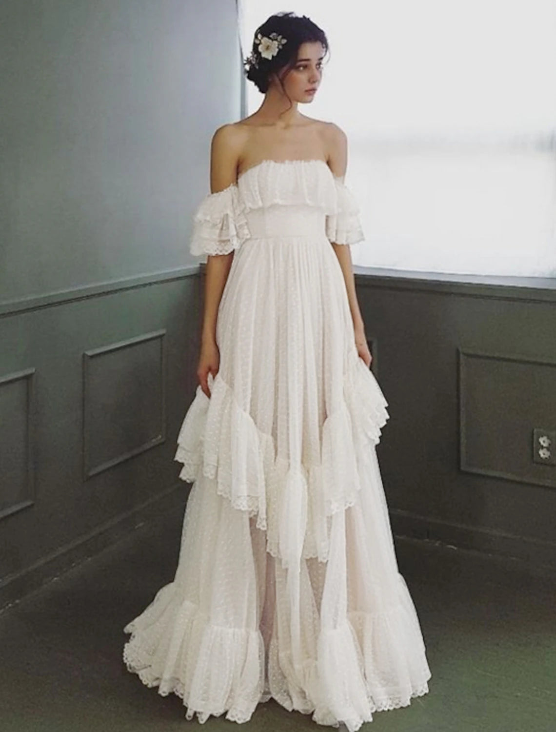 Elegant A-line off-shoulder cap sleeve tulle wedding dress with ruffles and sweep train.