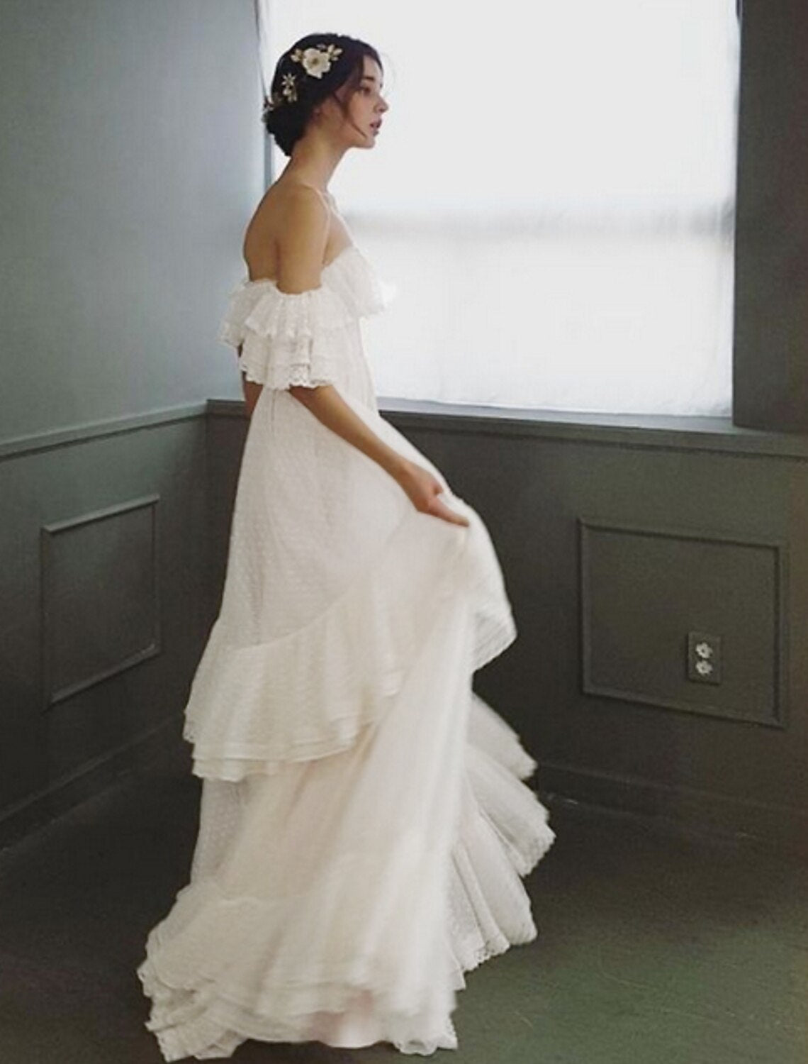 Side view of the A-line off-shoulder cap sleeve wedding dress with a sweep train.