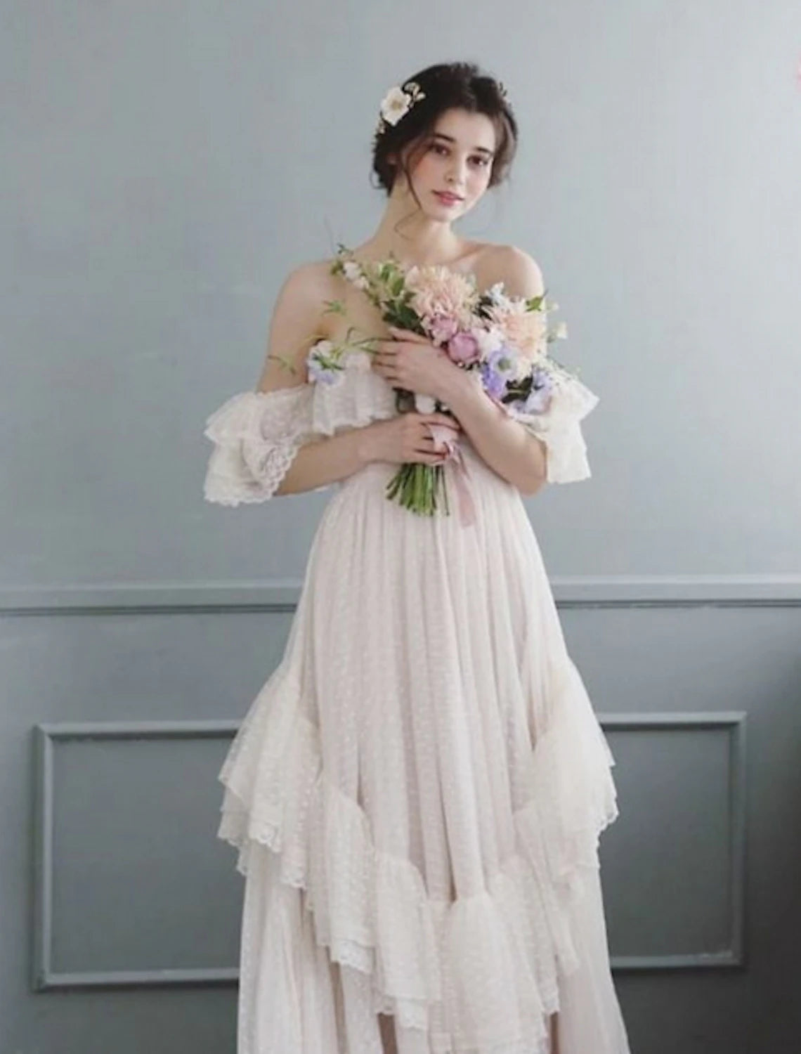 Full length view of the elegant off-shoulder tulle wedding dress with cap sleeves.