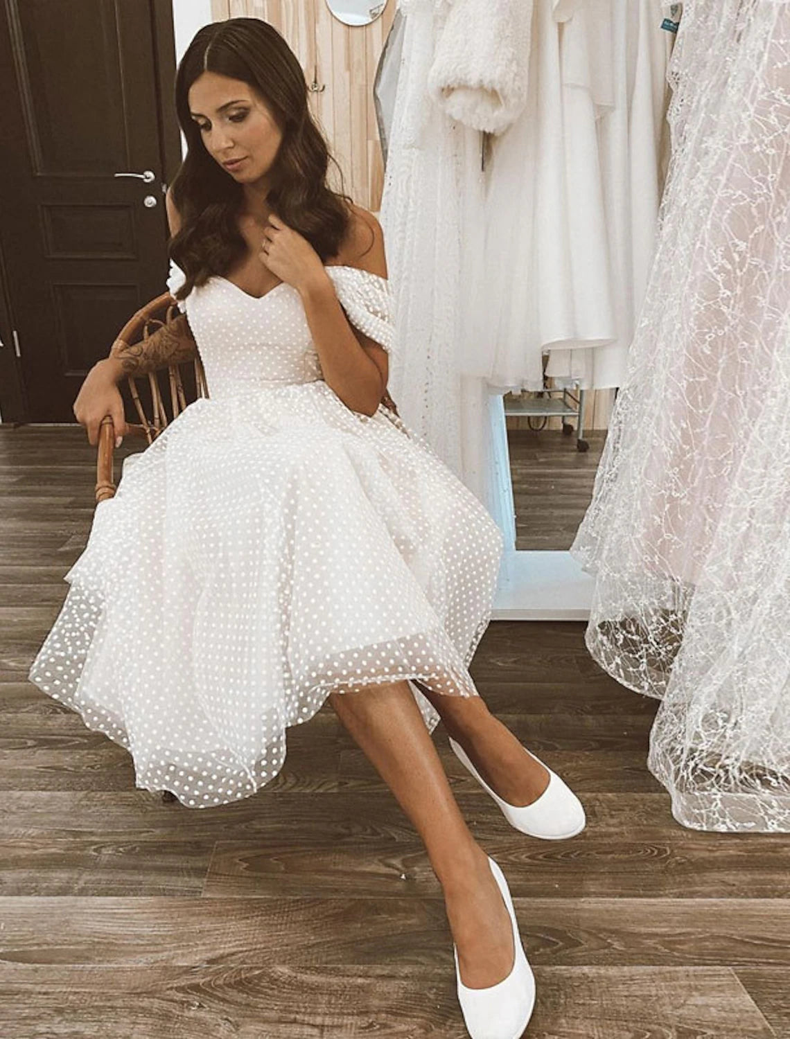 A-line off-shoulder cap sleeve tulle wedding dress in white, front view.