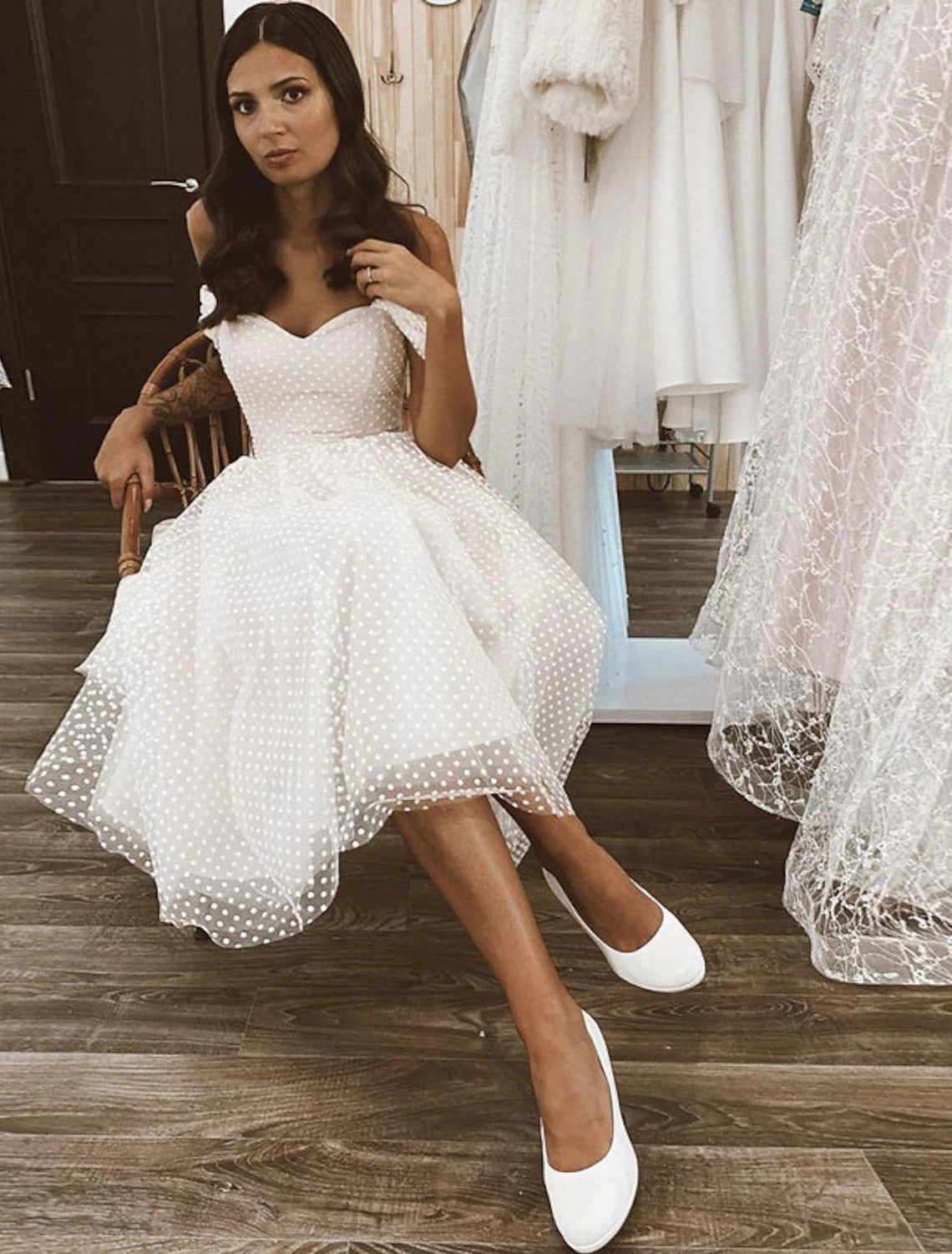 A-line off-shoulder cap sleeve tulle wedding dress in white, side view.