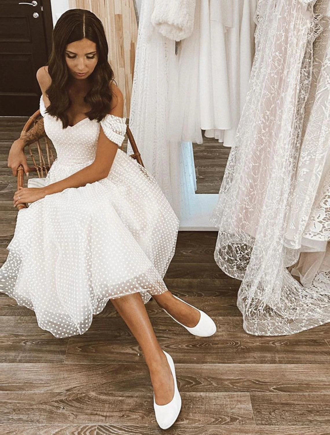 A-line off-shoulder cap sleeve tulle wedding dress in white, back view.
