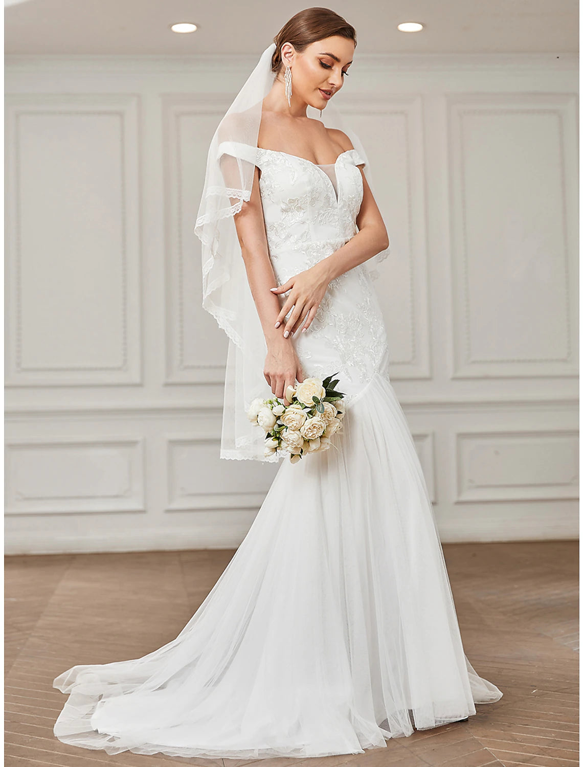 Vintage A-line wedding dress with off-shoulder cap sleeves and lace appliques.