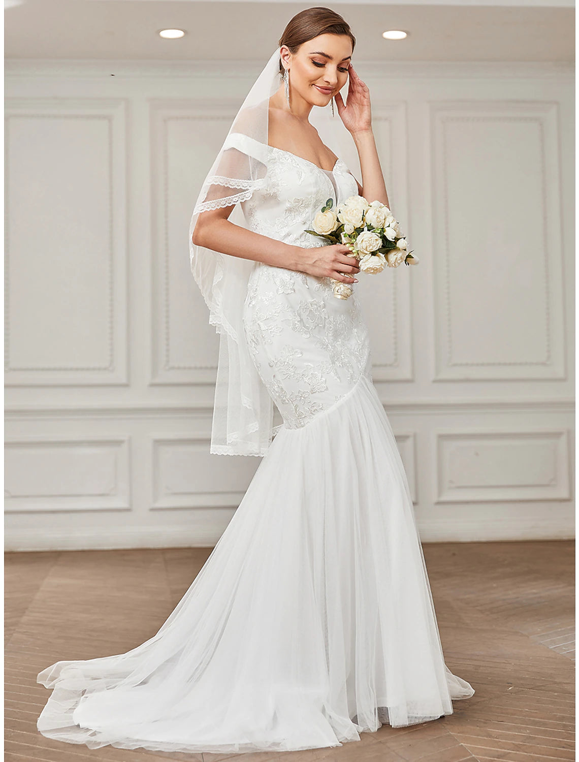 Close-up of the delicate lace appliques on the vintage wedding dress.