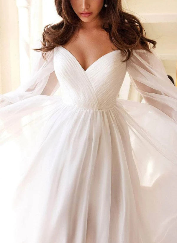Side view of floor-length chiffon bridal dress.