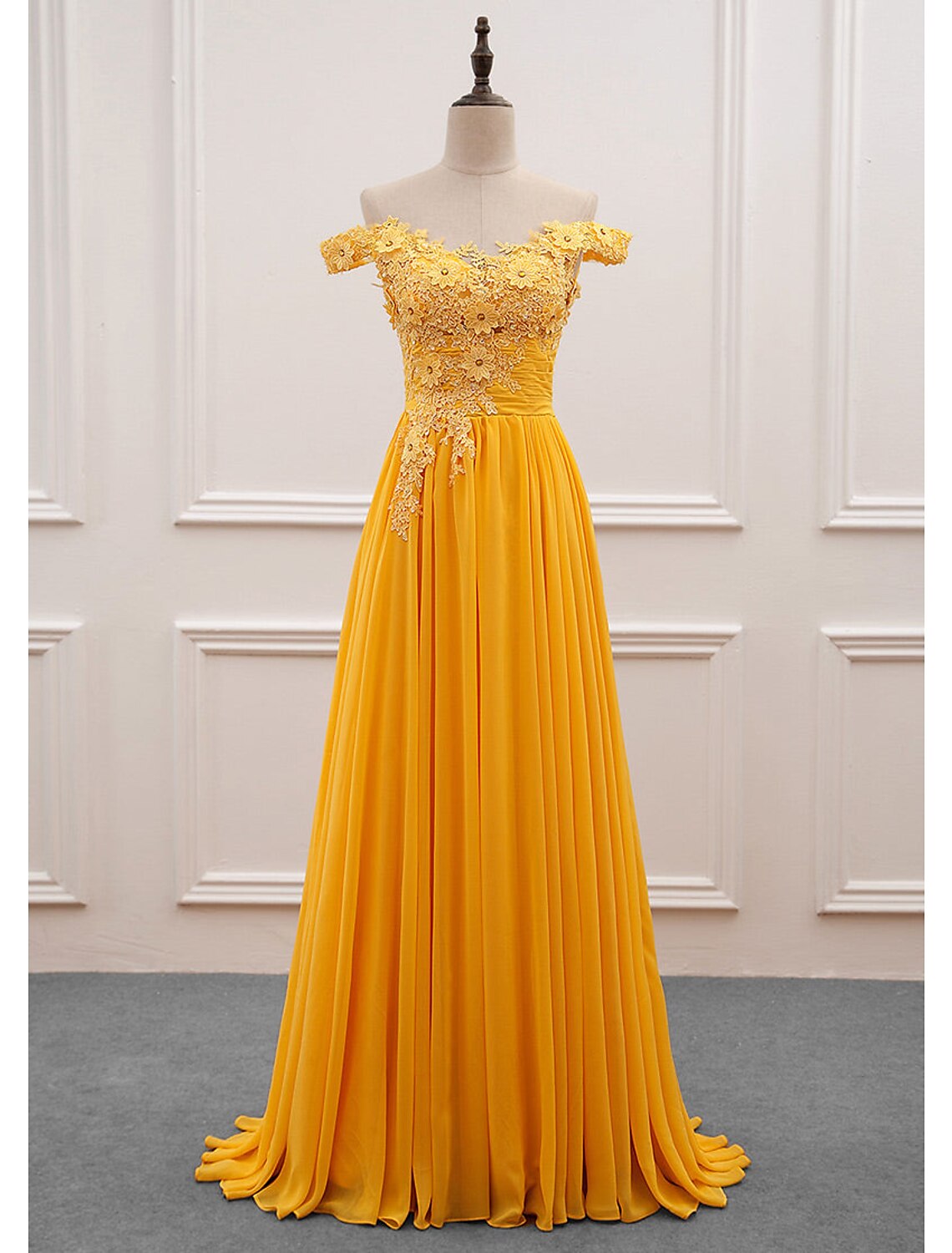Elegant A-line off-shoulder chiffon dress with floral appliques and a sweep train.