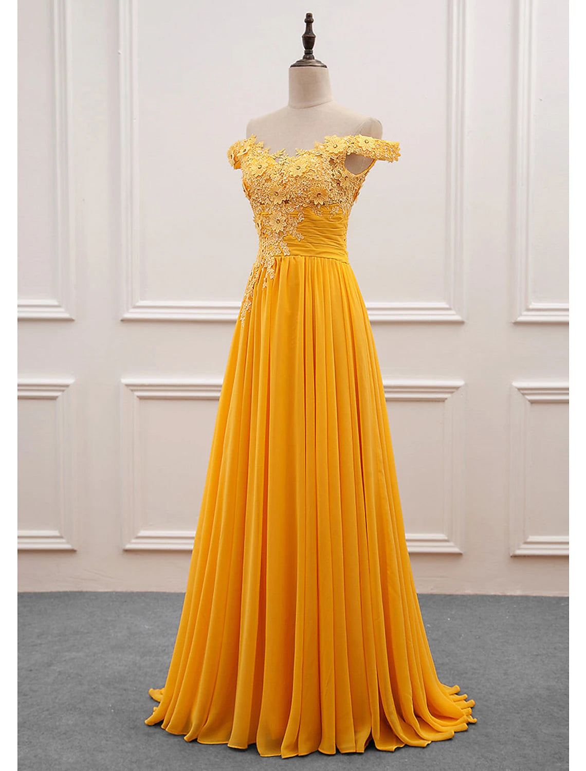 Close-up of the delicate floral appliques on the elegant chiffon dress.