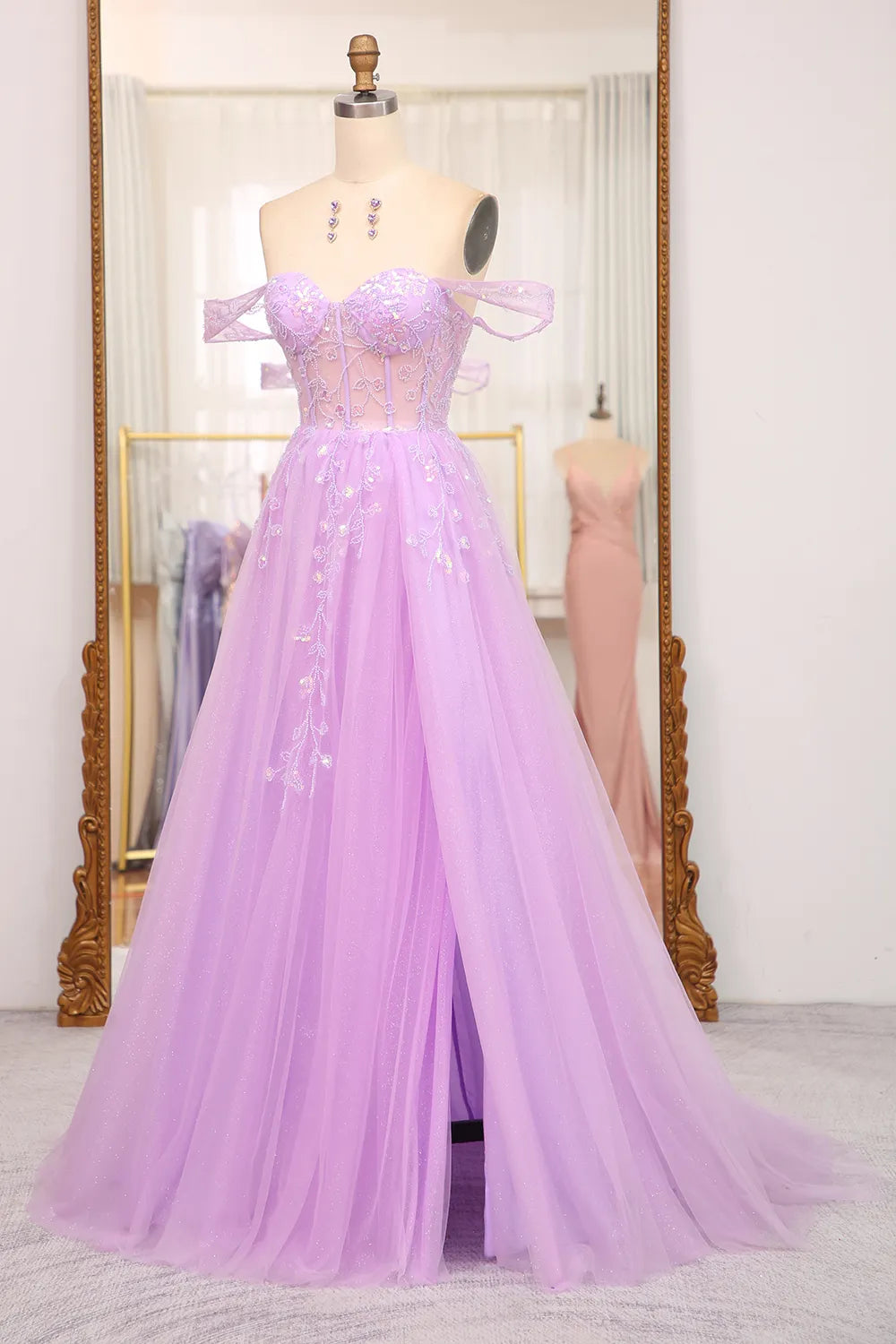Back view of the long A-line off-shoulder gown, showcasing its elegant drape.
