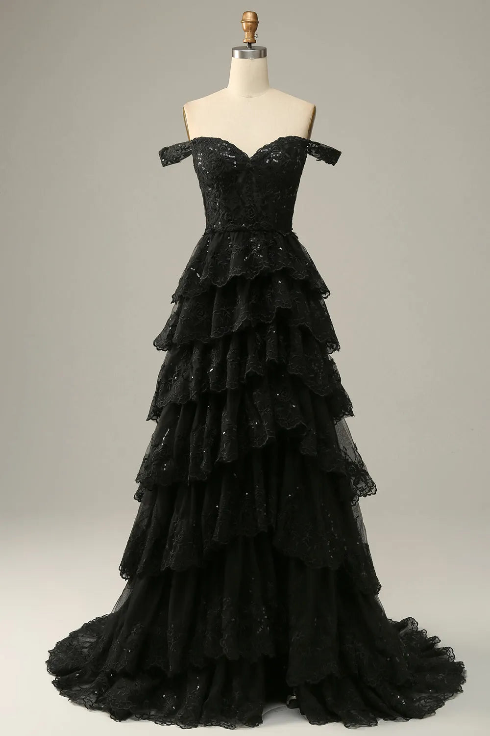 Close-up of the corset bodice and lace ruffles on the off-shoulder prom dress.