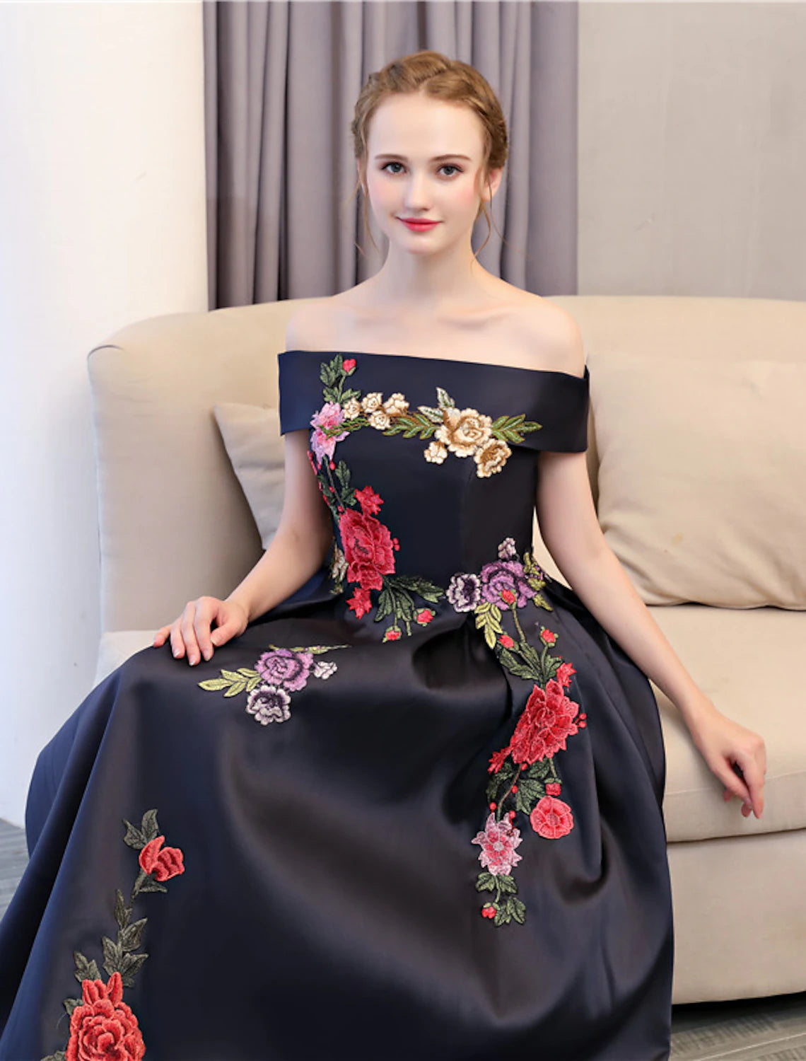 Side profile of a woman in the elegant off-shoulder satin dress.