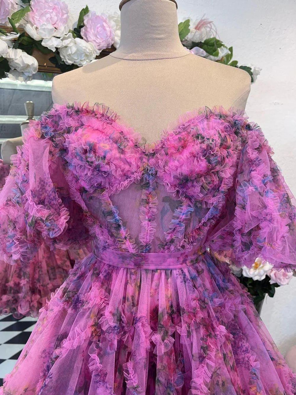 Woman wearing an A-line off-shoulder floral printed midi dress.
