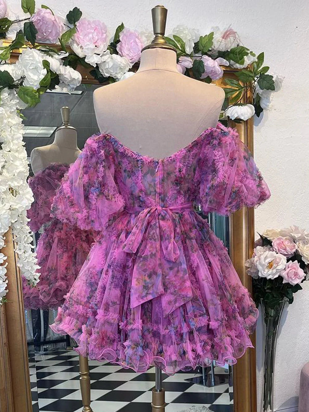 Back view of an A-line off-shoulder floral printed dress.