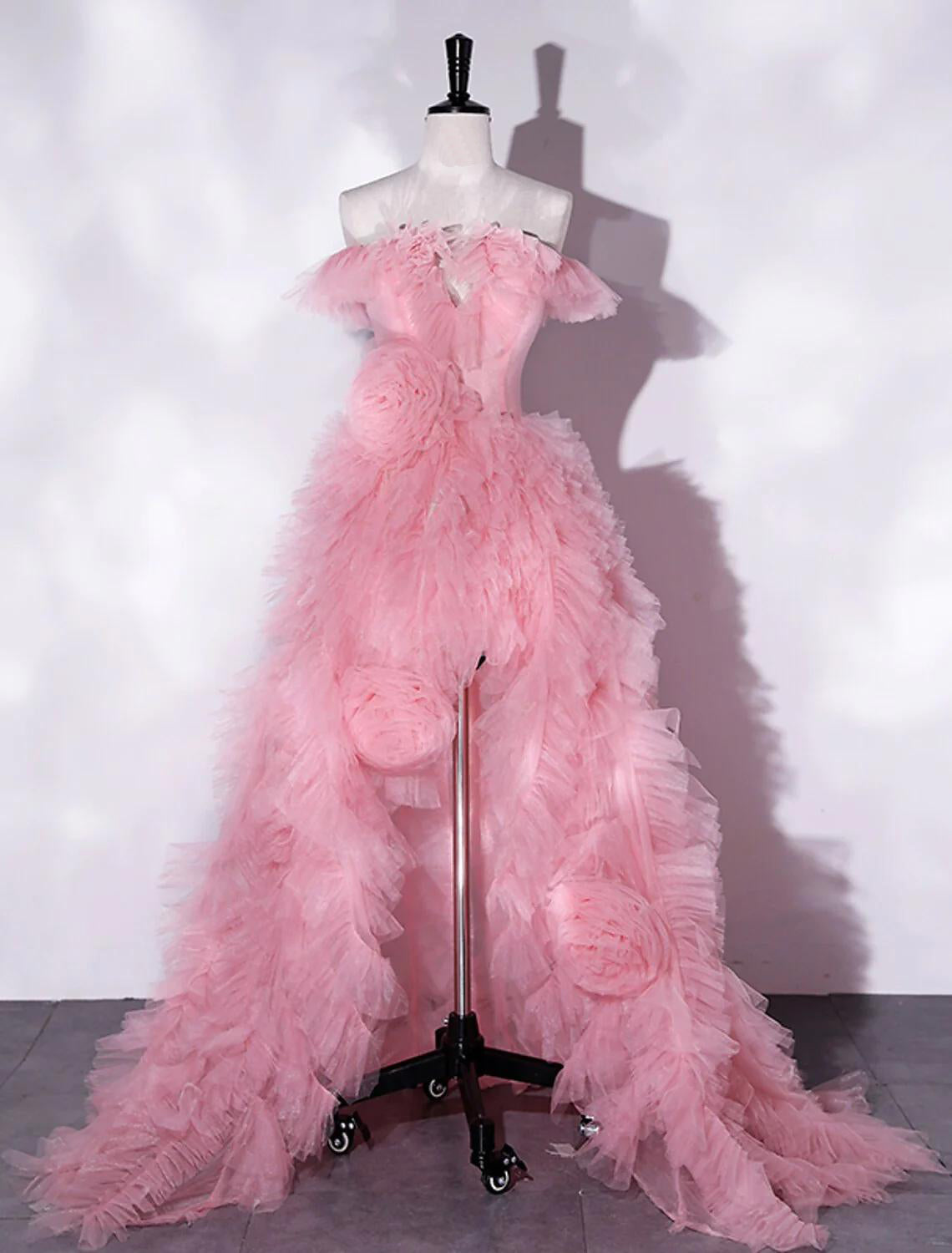 Woman wearing an elegant A-line off-shoulder floral tulle maxi prom dress with a high slit.