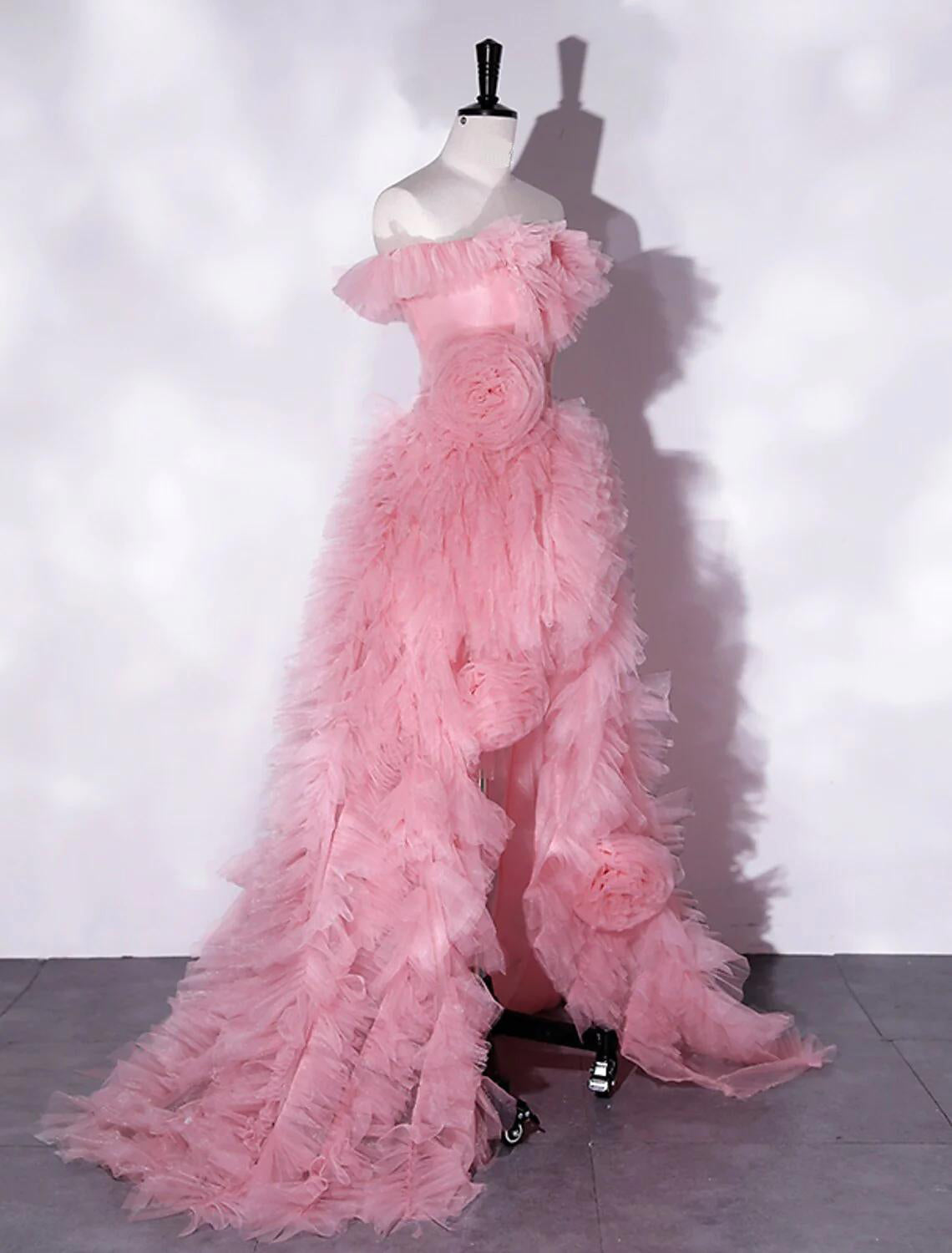 Close-up of the delicate floral pattern and tulle fabric on the off-shoulder prom dress.