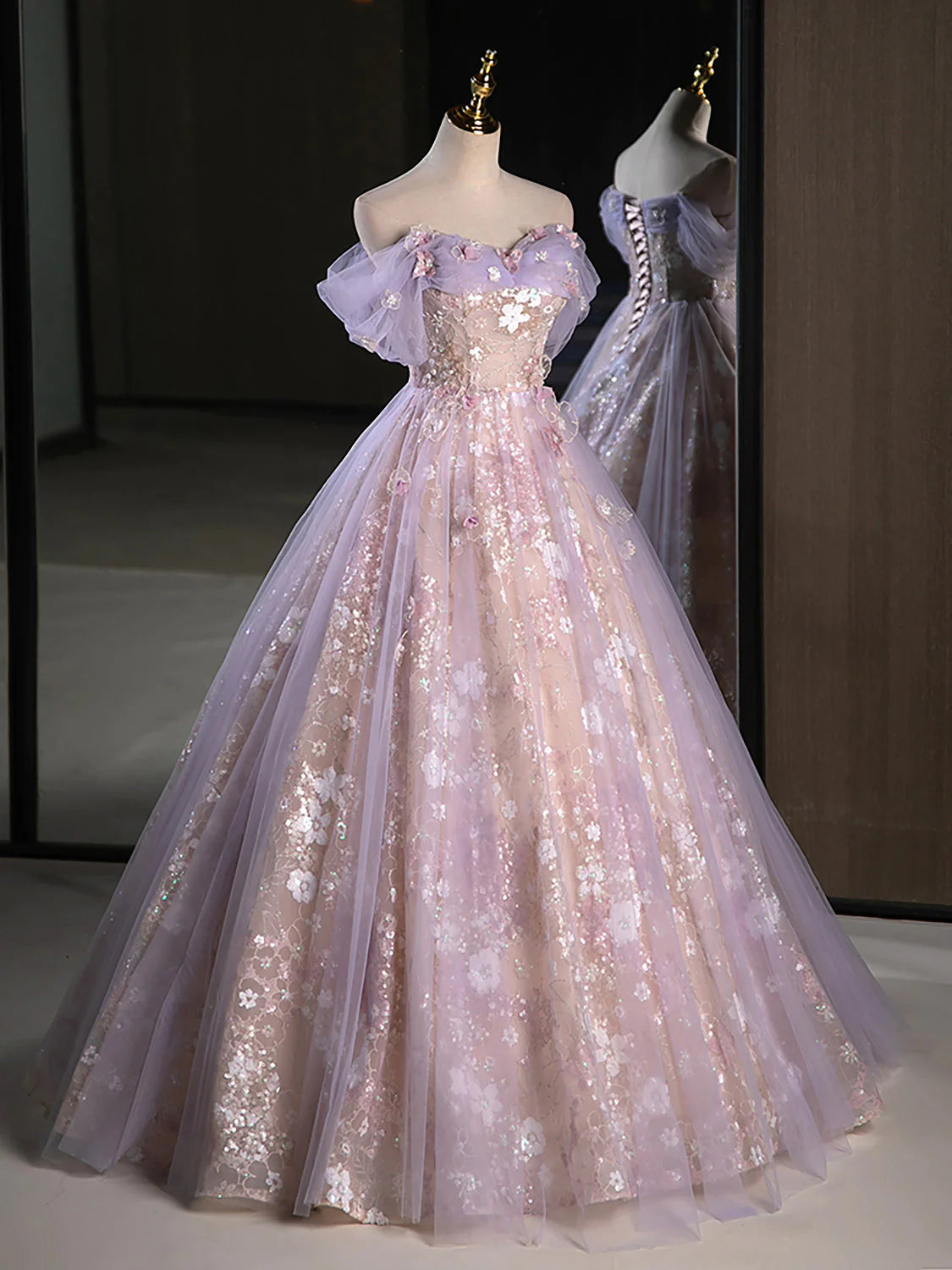 Model posing in a sophisticated A-line off-shoulder evening dress.