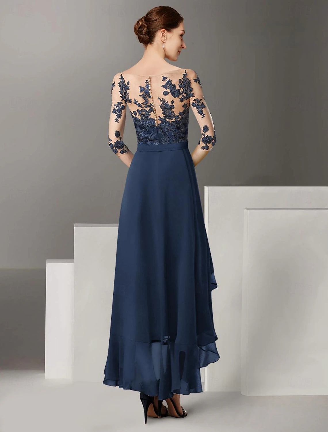 Back view of the A-line off-shoulder dress showing pleats and ankle length.