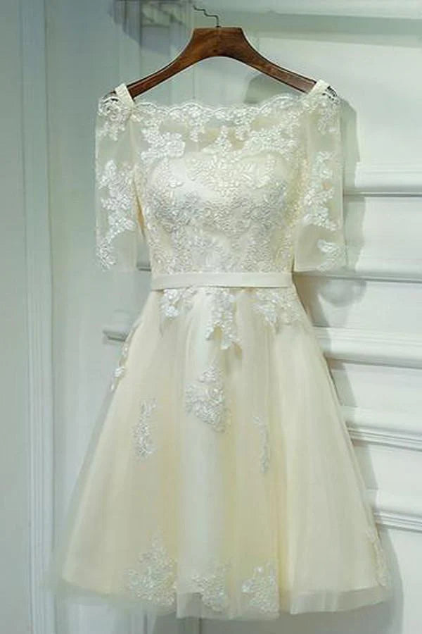 Model wearing a short, off-shoulder, half-sleeve A-line homecoming dress with lace-up back and floral appliques.