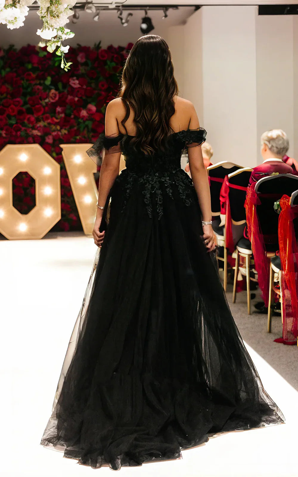 Back view of A-line off-shoulder wedding dress with lace details.