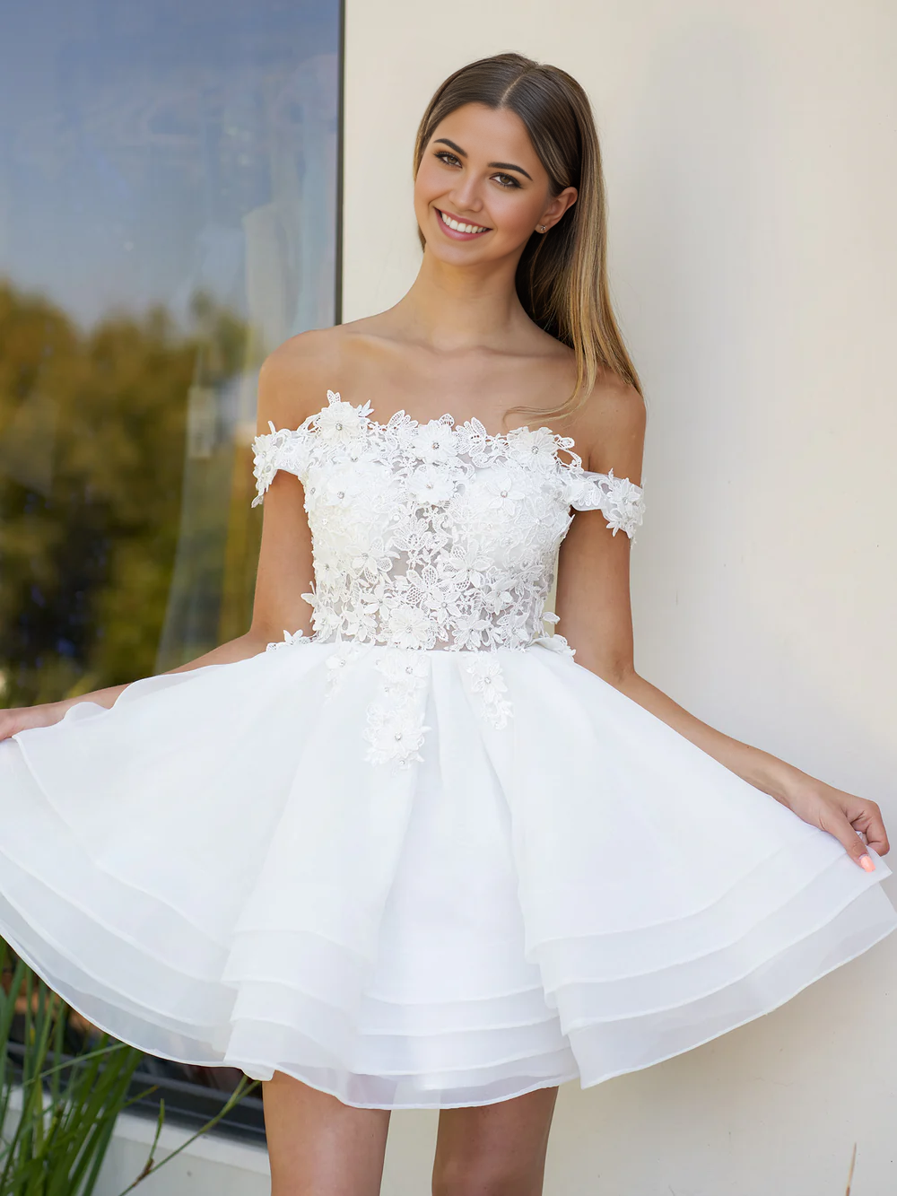 Side profile of a bride in an A-line off-shoulder organza wedding dress.