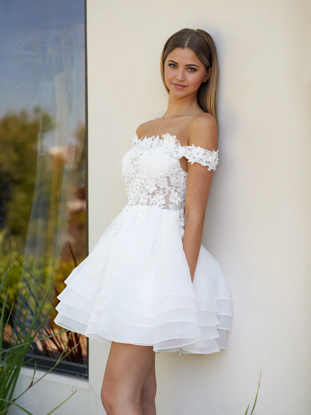Close-up of the lace and organza details on the off-shoulder wedding dress.
