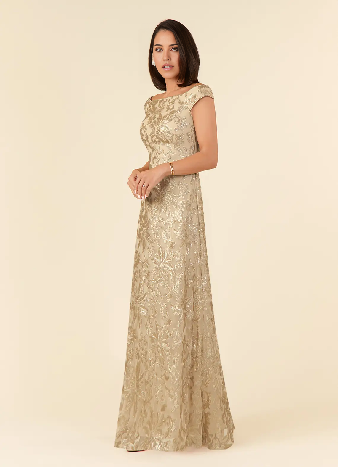 Close-up of the intricate lace detail on a champagne off-shoulder dress.