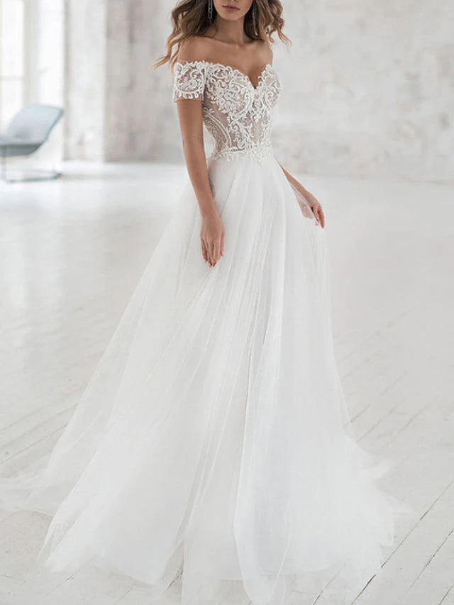 Elegant A-line off-shoulder wedding dress with lace bodice and flowing tulle skirt.