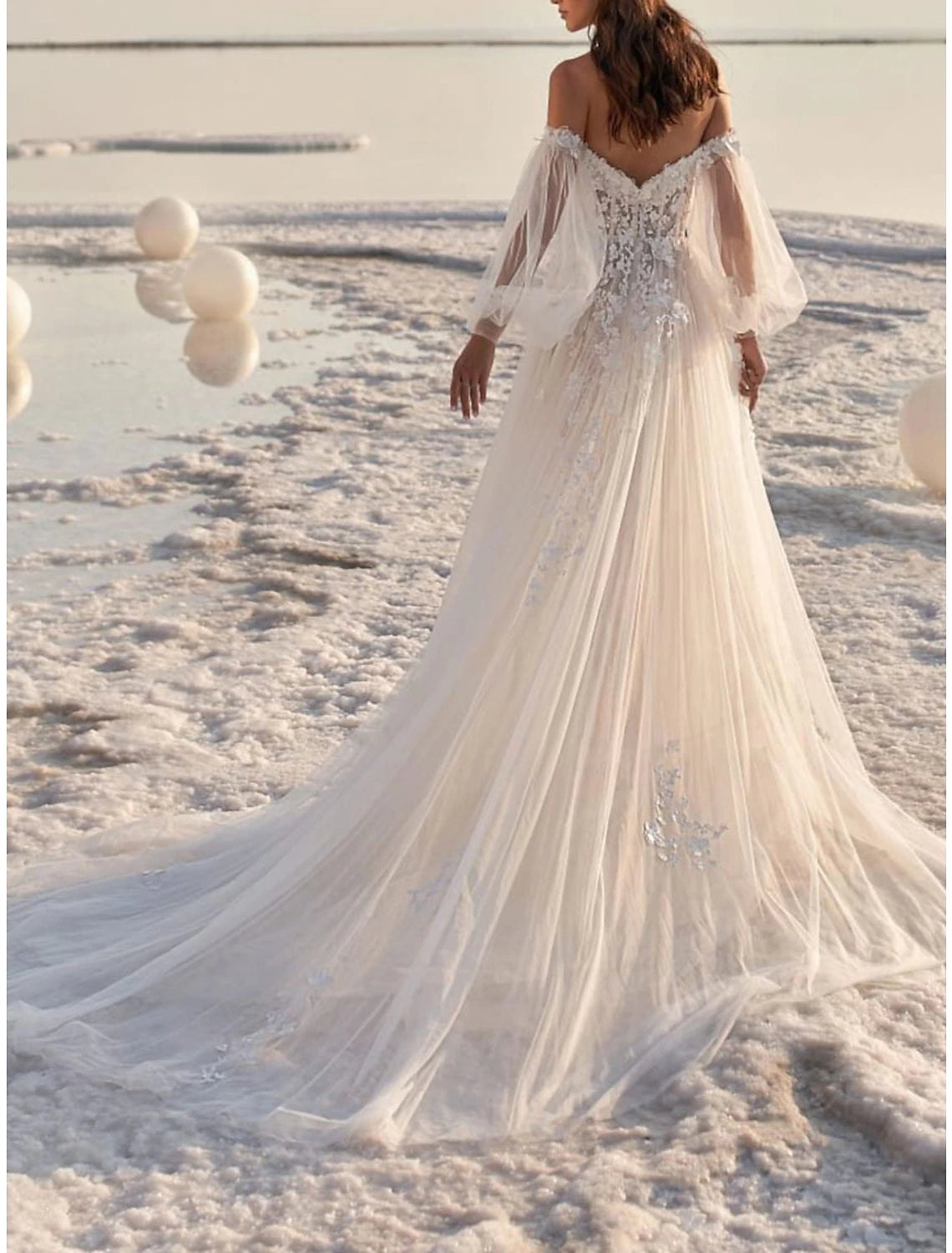 Back view of the A-line wedding dress, showing the court train and lace details.