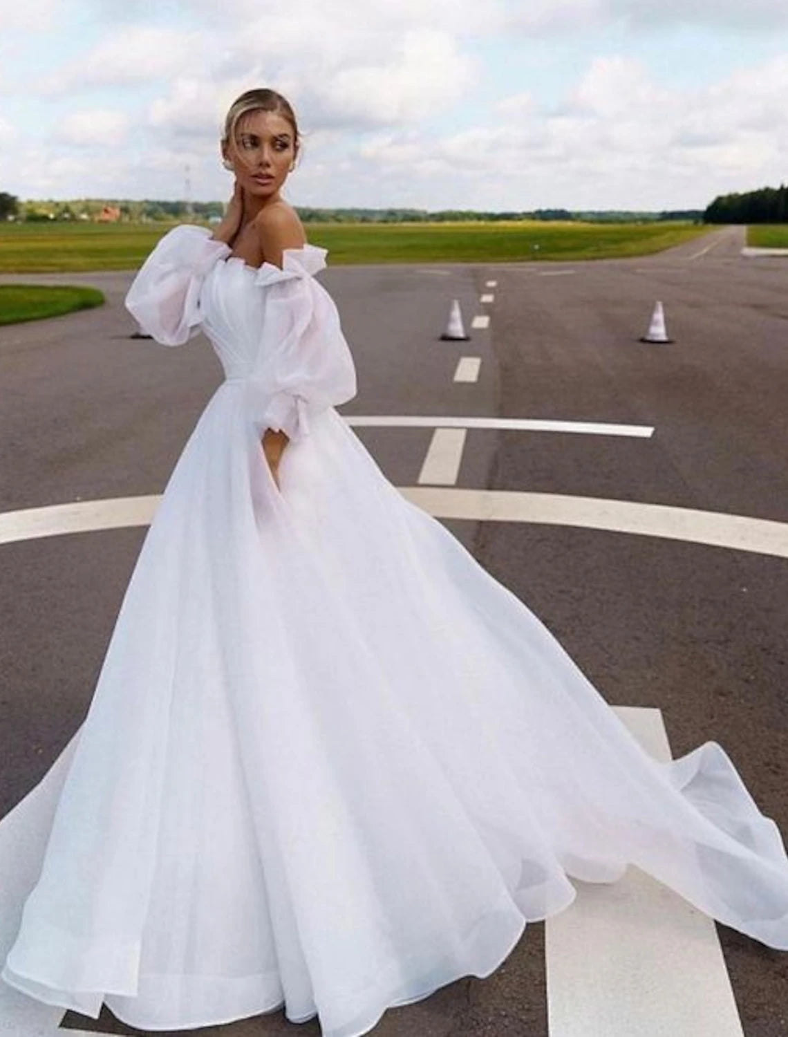 Elegant A-line off-shoulder organza wedding dress with long sleeves and a court train.