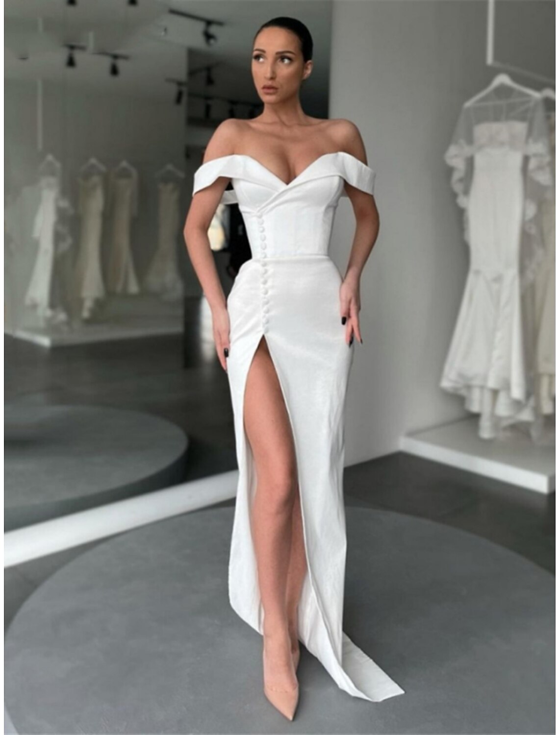 Side view of A-Line evening gown highlighting the long sleeve and elegant slit.