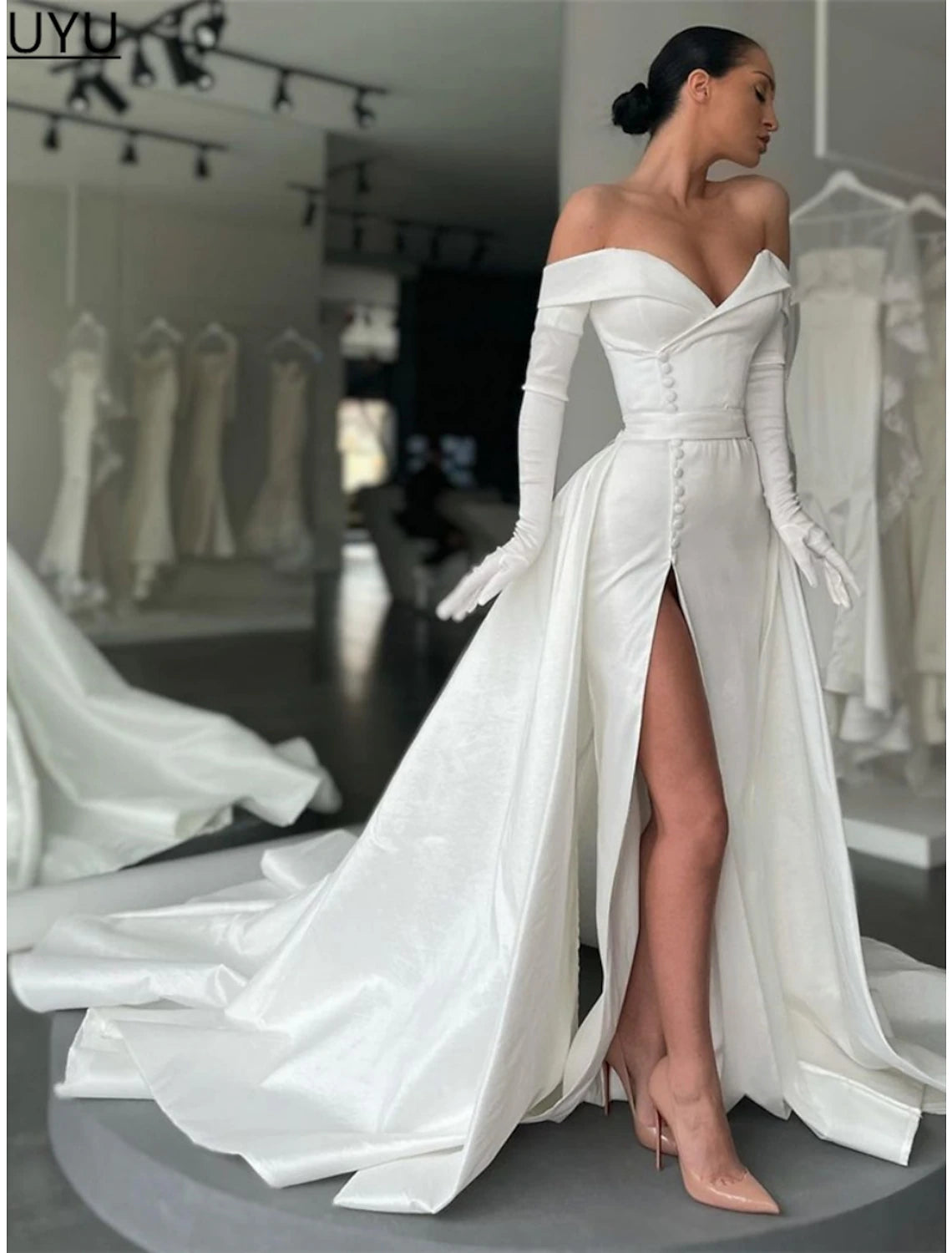 Close-up of the off-shoulder neckline and satin fabric of the formal dress.
