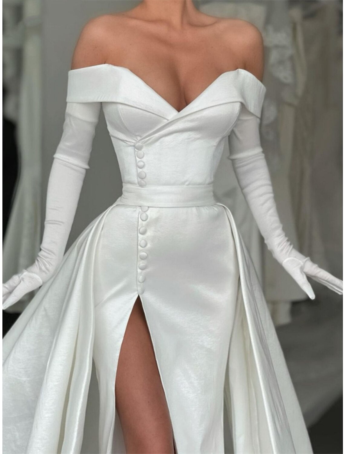 Detail of the buttons and pleats on the back of the satin evening dress.