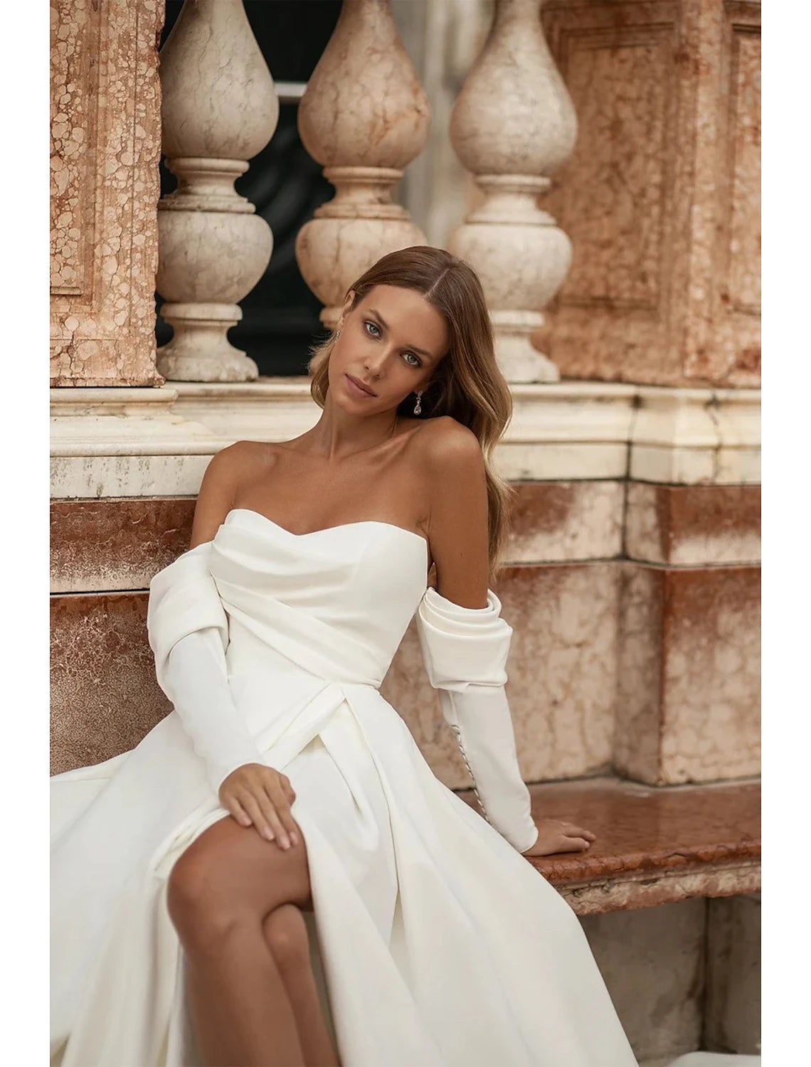 A-Line off-shoulder long sleeve satin wedding dress with a split front.
