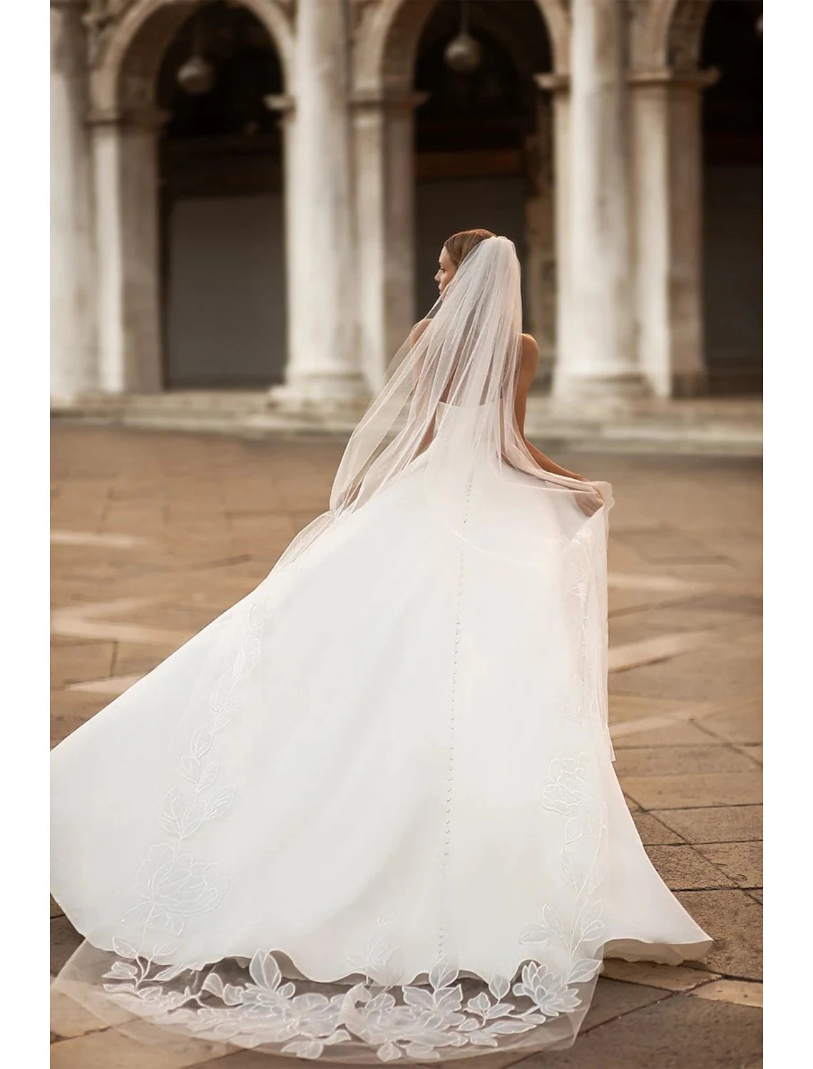 Back view of the A-Line satin bridal gown showing the court train.