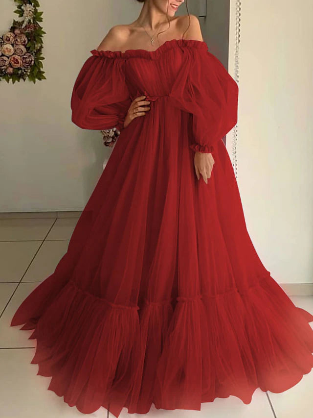 Close-up of the off-shoulder neckline and long sleeves of the elegant dress.