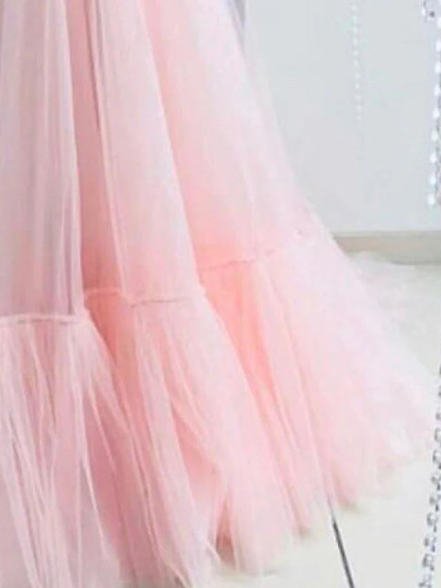 Side view of the floor-length A-line tulle dress with appliques.