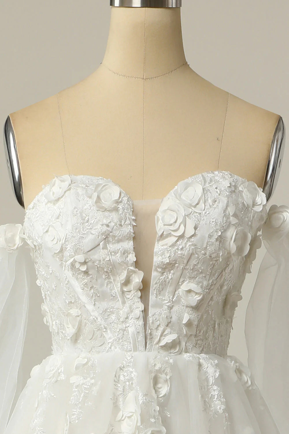 Side view of off-the-shoulder wedding dress with flowing skirt.