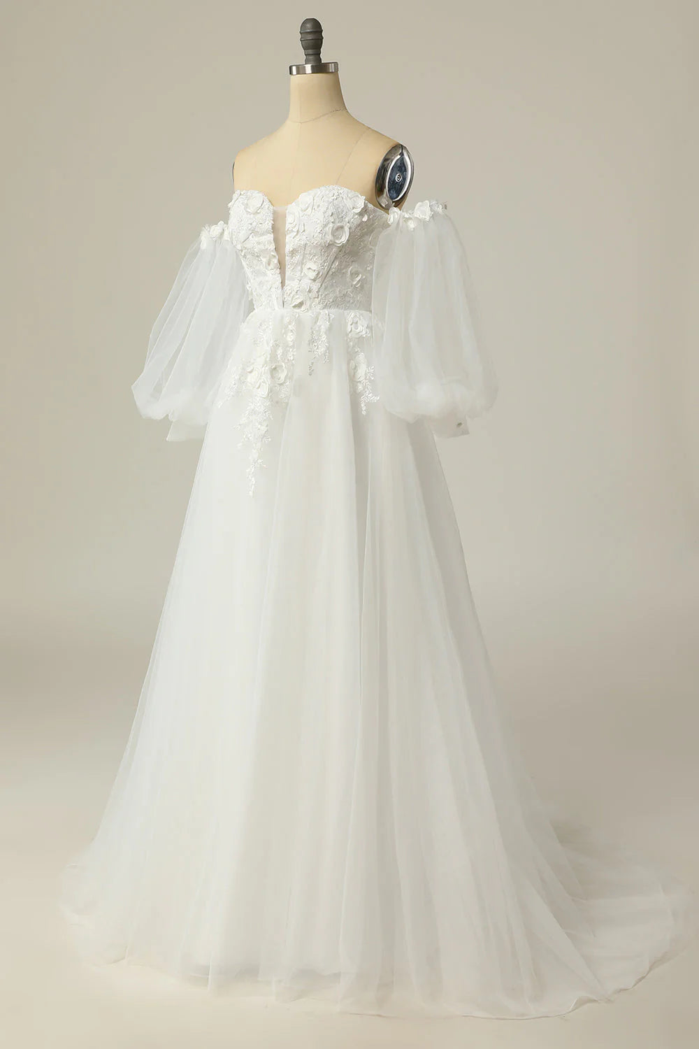 Close-up of the long sleeves and off-the-shoulder neckline on a wedding dress.