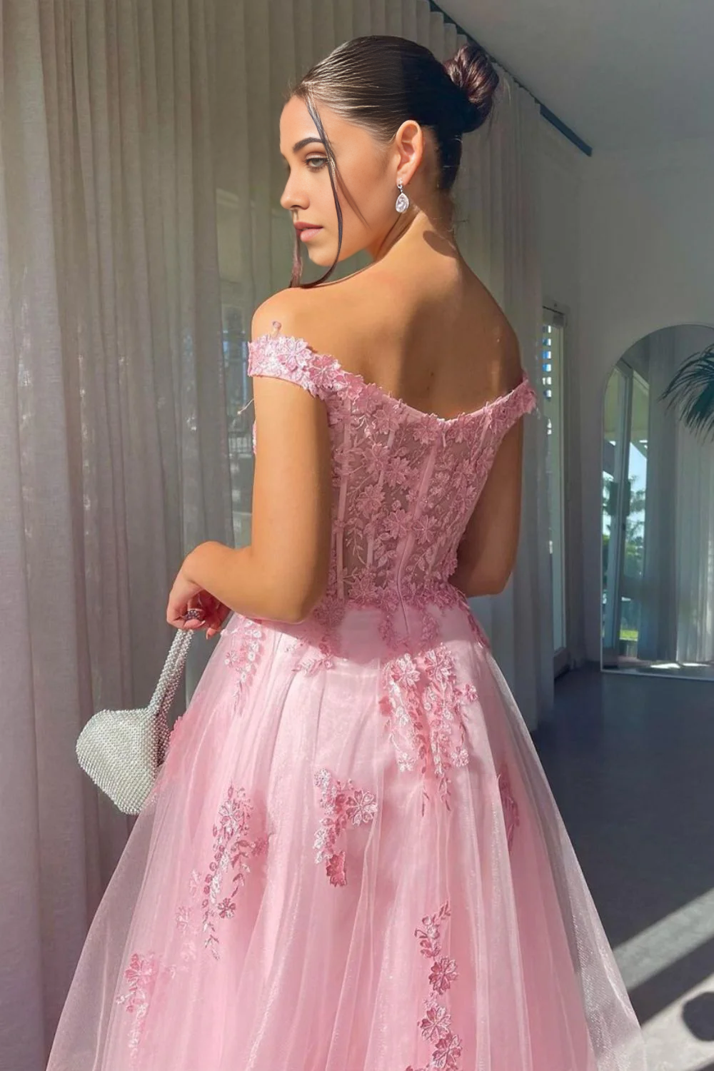 Front view of a long pink A-line prom dress featuring off-shoulder neckline and appliques.