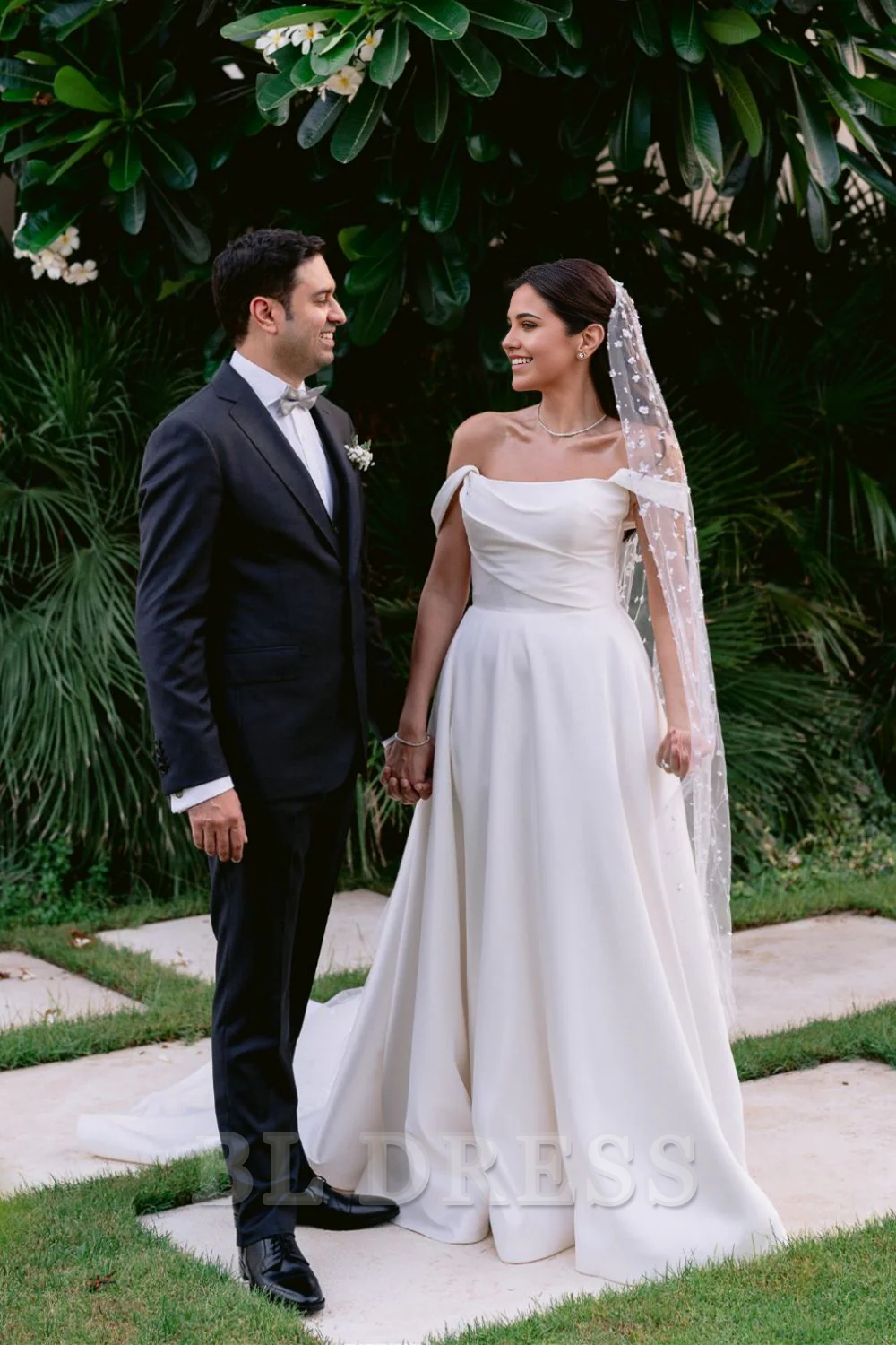 Elegant A-line off-shoulder white long wedding dress on a model.