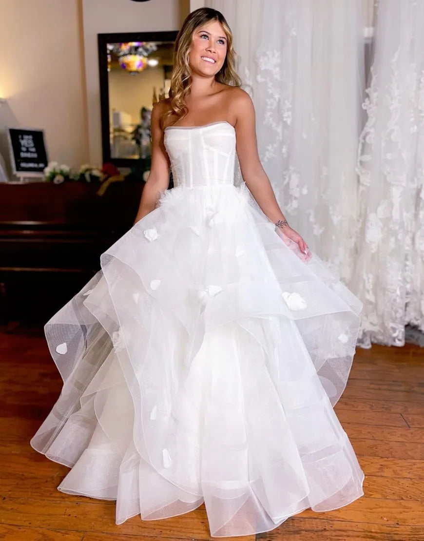Elegant white A-line off-shoulder wedding dress with ruffles.