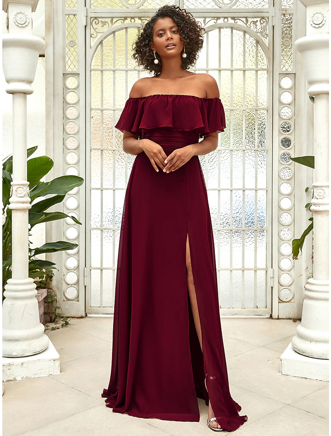 Side view of the floor-length ruffled chiffon bridesmaid gown.