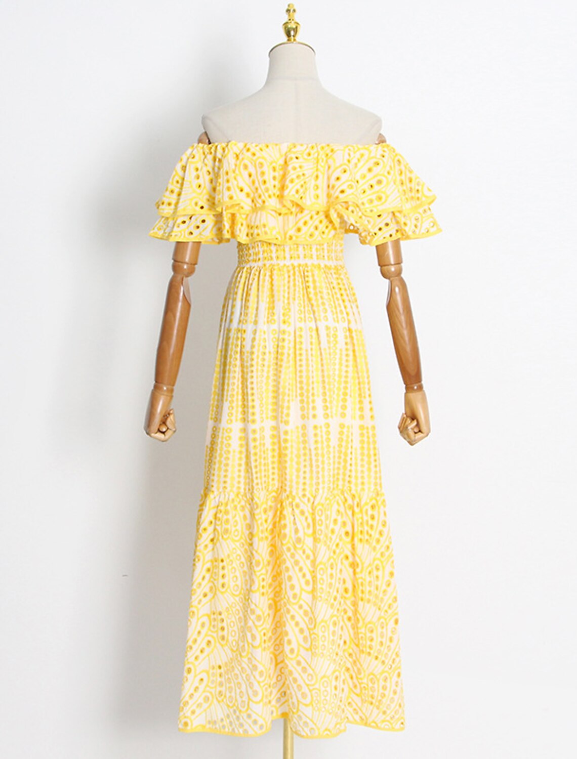 Back view of an A-line off-shoulder dress, showcasing the ankle length and ruffled details.